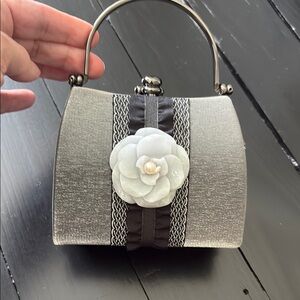 Elegant Silver and Black Handbag with Floral Accent
